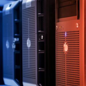 Close-up of tower servers in a data center with blue and red lighting.
